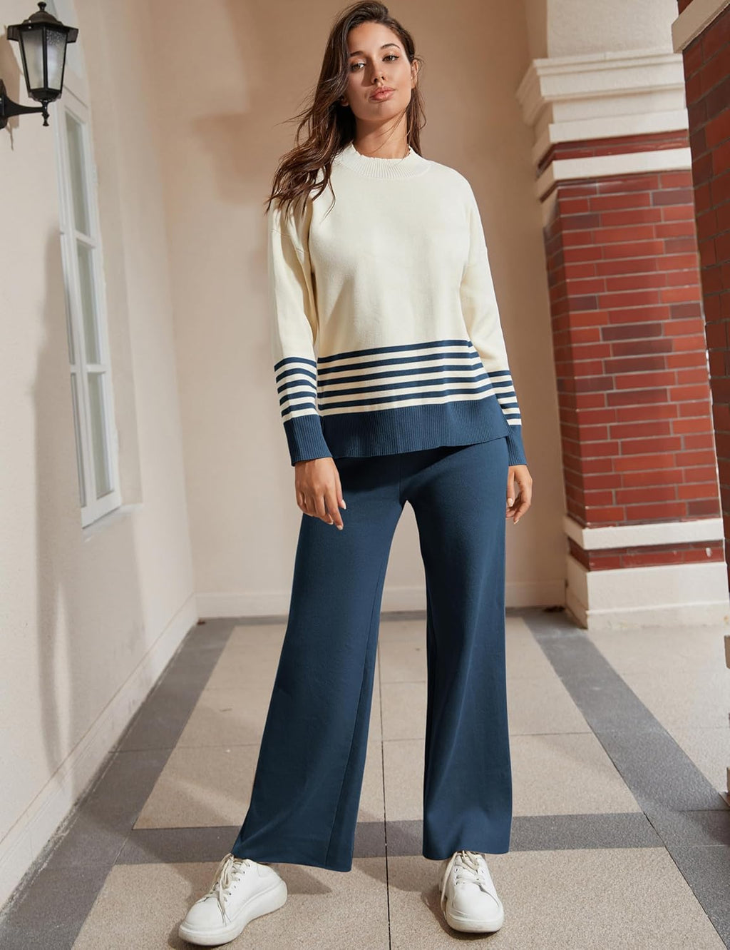 Women's 2-piece lounge set on model: cream knit top with navy striped cuffs, wide-leg pants