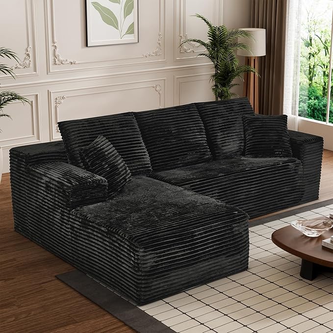 Black corduroy sectional sofa with right chaise, deep seats, and throw pillows