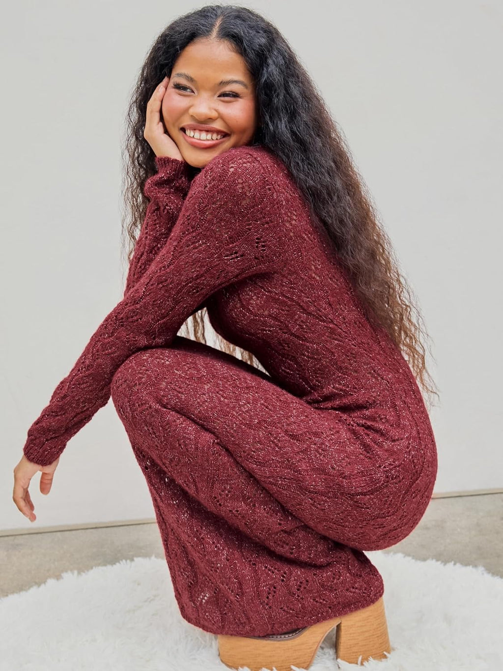 Burgundy long-sleeve crewneck maxi sweater dress with textured knit close-up.