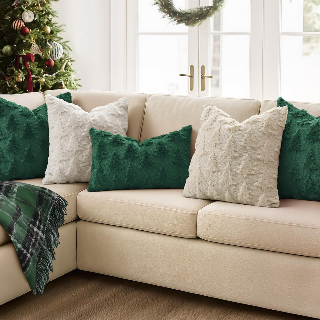 Dark green and white Christmas tree throw pillow covers on a beige sofa