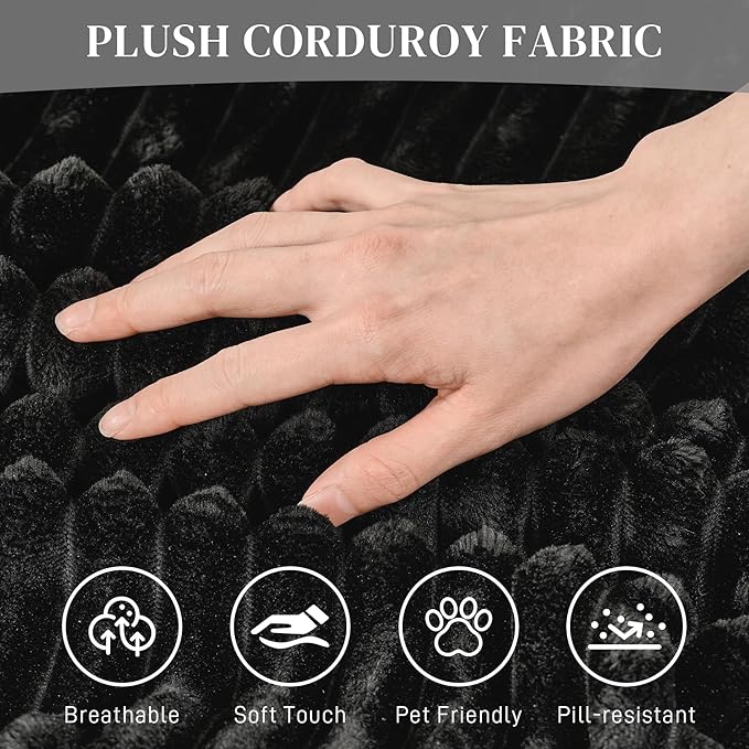 Black plush corduroy upholstery texture with hand touching the fabric