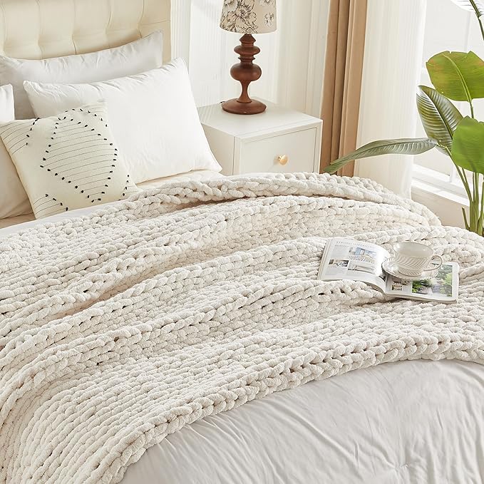 Cream chunky knit throw blanket on bed, thick chenille loop cable knit texture