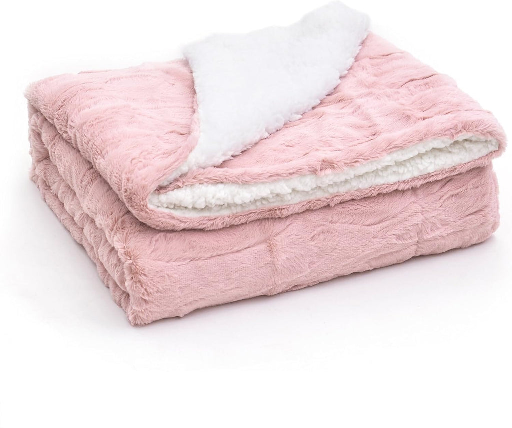 Folded dusty pink faux fur throw blanket with white reverse edge