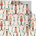 Nutcracker Christmas wrapping paper with repeating toy soldier pattern on yellow background.