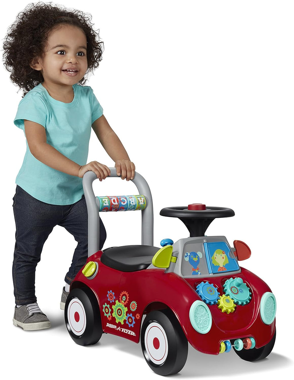 Red toddler sit-to-stand ride-on car with music-style top button and activity dashboard