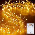 Warm white fairy string lights on silver wire with battery pack shown at right.