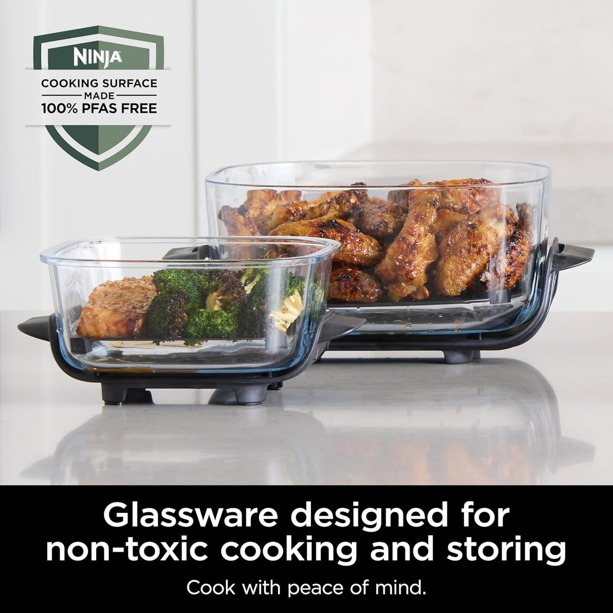 Air fryer with clear glass containers showing cooked chicken and greens