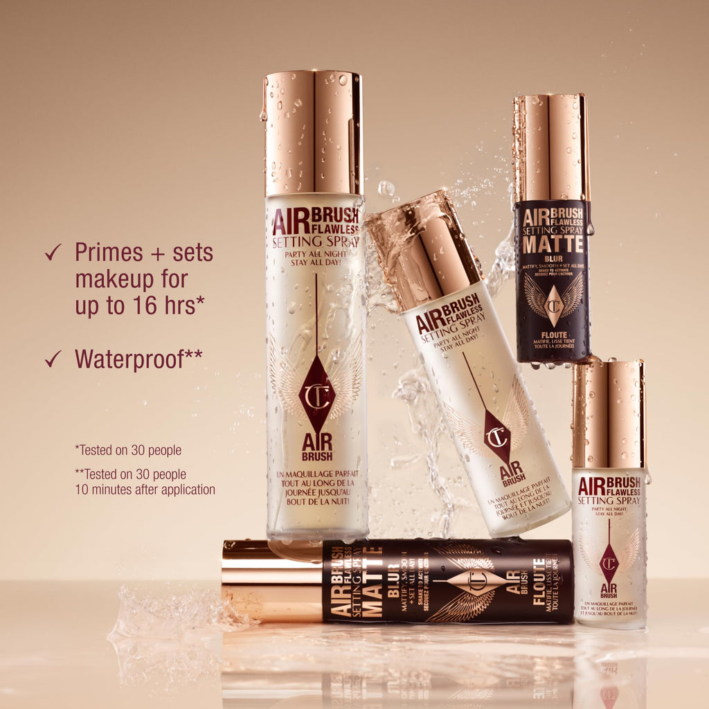 Assorted Airbrush bottles with water droplets, including Charlotte Tilbury Airbrush Flawless spray