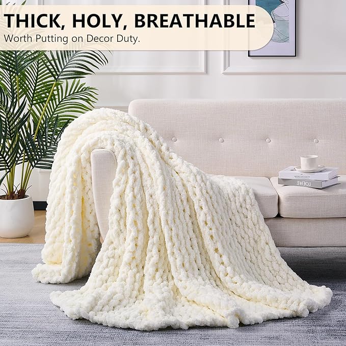 Cream chunky knit blanket throw, thick cable design draped across couch