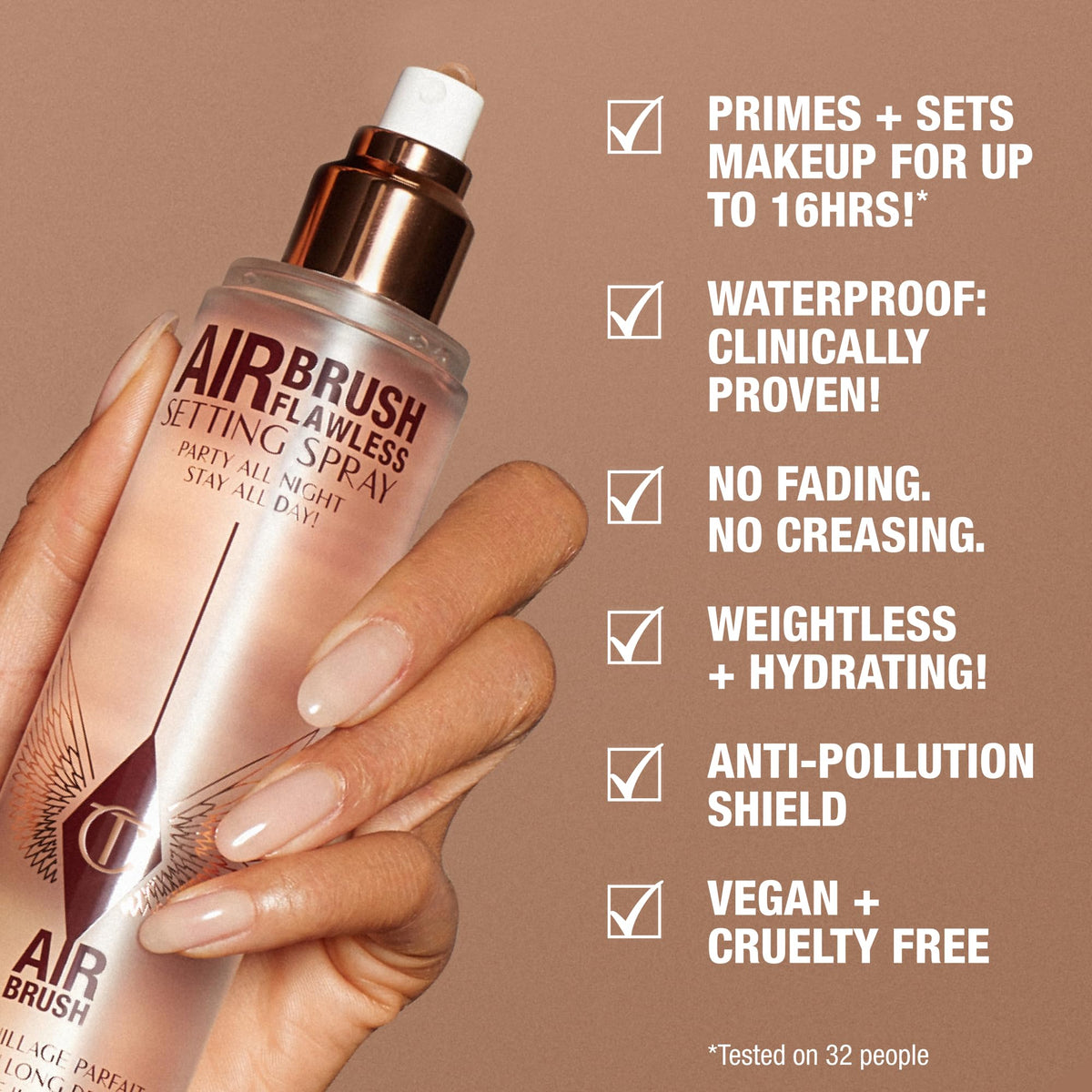 Rose-gold and clear airbrush setting spray bottle held in a hand