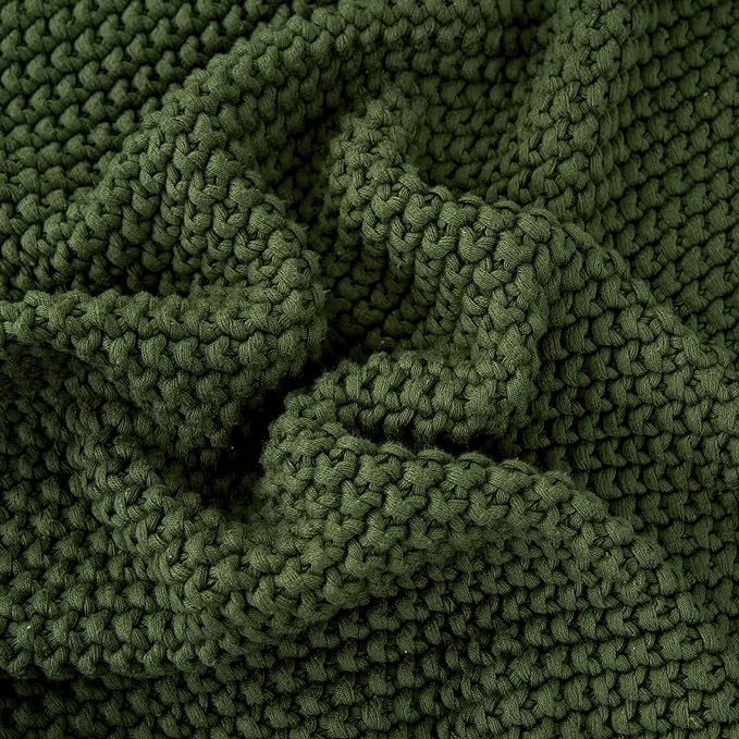 Close-up of olive green chunky cable-knit throw blanket texture