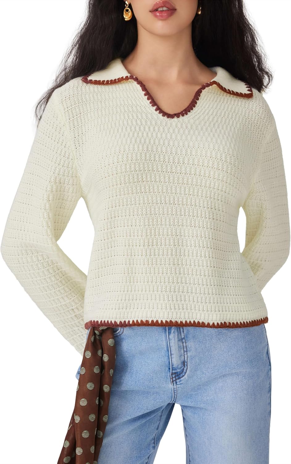 Beige V-neck knit sweater with long sleeves and contrast trim, styled with blue jeans