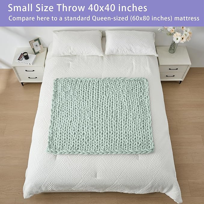 Mint 40x40 chunky knit throw blanket folded on bed, thick rope-cable stitch texture.