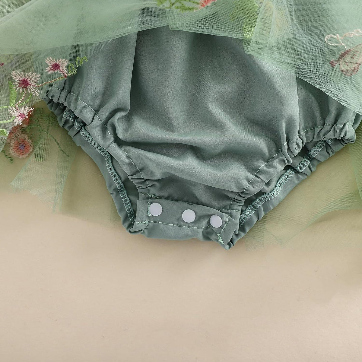 Green tulle romper shorts with ruffle hem and embroidered mesh leg openings