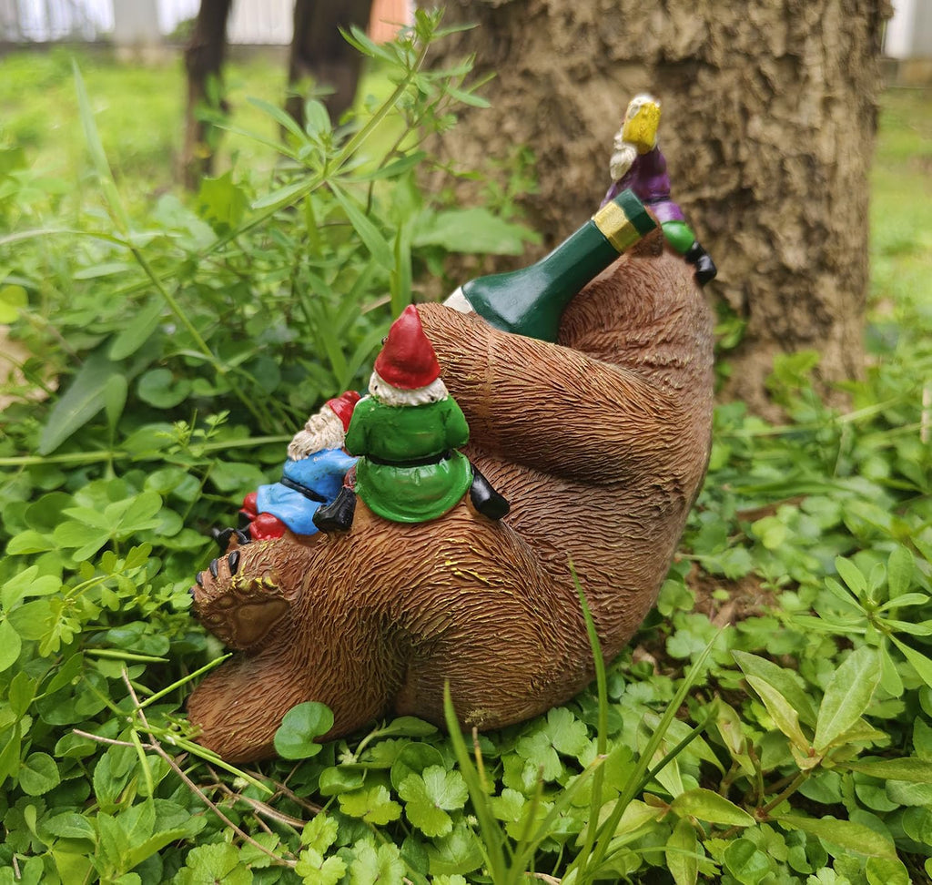 Garden bear yard statue with gnomes perched on bear back and green beer bottle