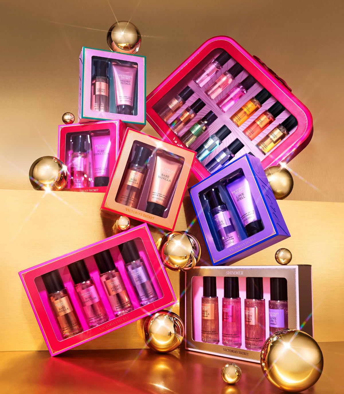 Fragrance mist gift set with four mini bottles in pink and purple open boxes