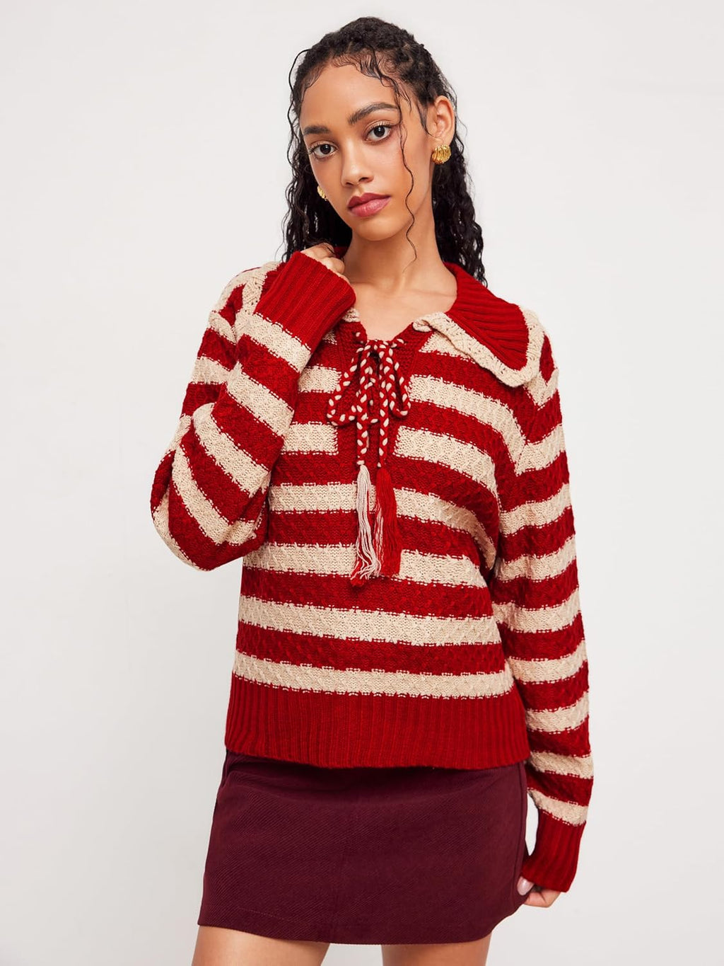 Red and cream striped knit pullover sweater with tassel drawstring and ribbed trim