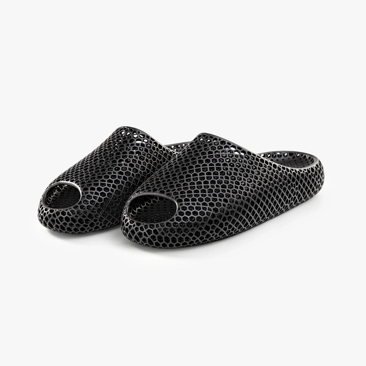 Black 3D-printed mesh slippers, angled view showing multiple toe openings.