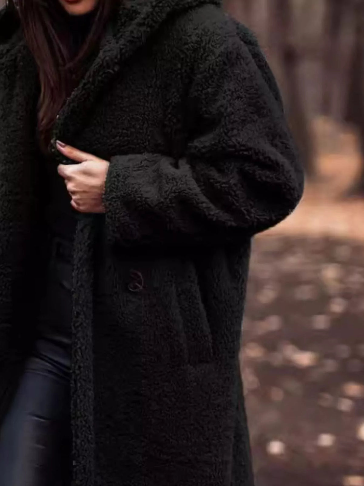 Black teddy-fleece longline coat with hood and button-front closure