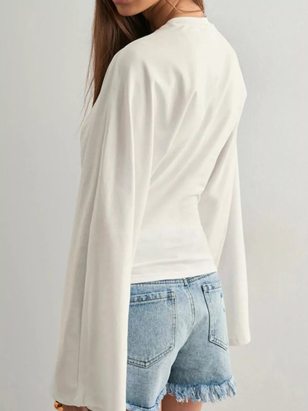 Plus size fitted long-sleeve T-shirt in white, side view, crew neck and flared sleeves