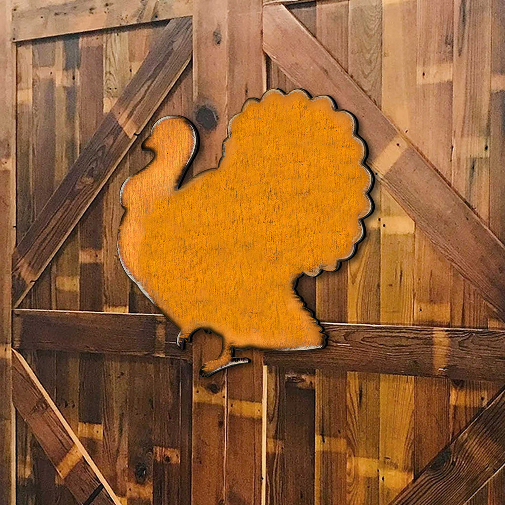 Orange wooden turkey door hanger mounted on rustic wood boards