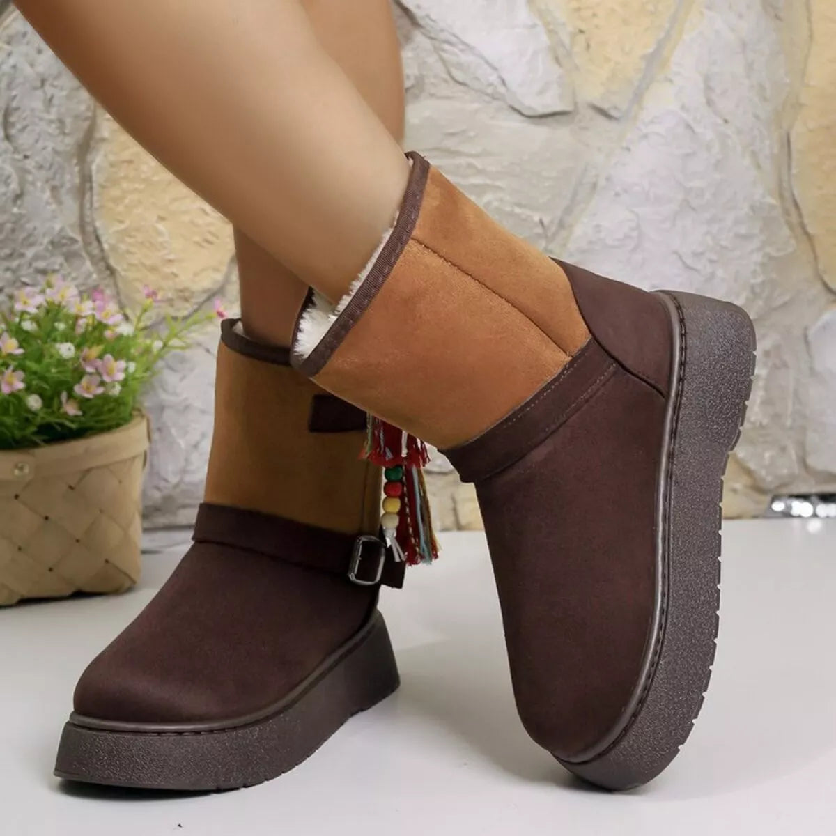 Two-tone ankle boots with tassel keychain, buckle strap, and chunky dark sole.