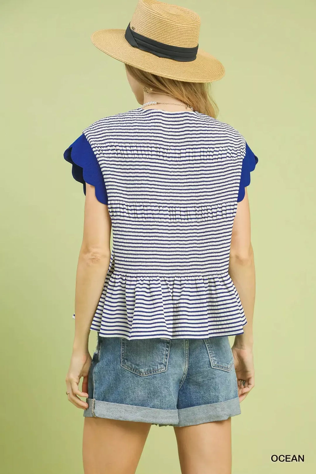 Back view of navy-and-white striped peplum top with ruffle cap sleeves