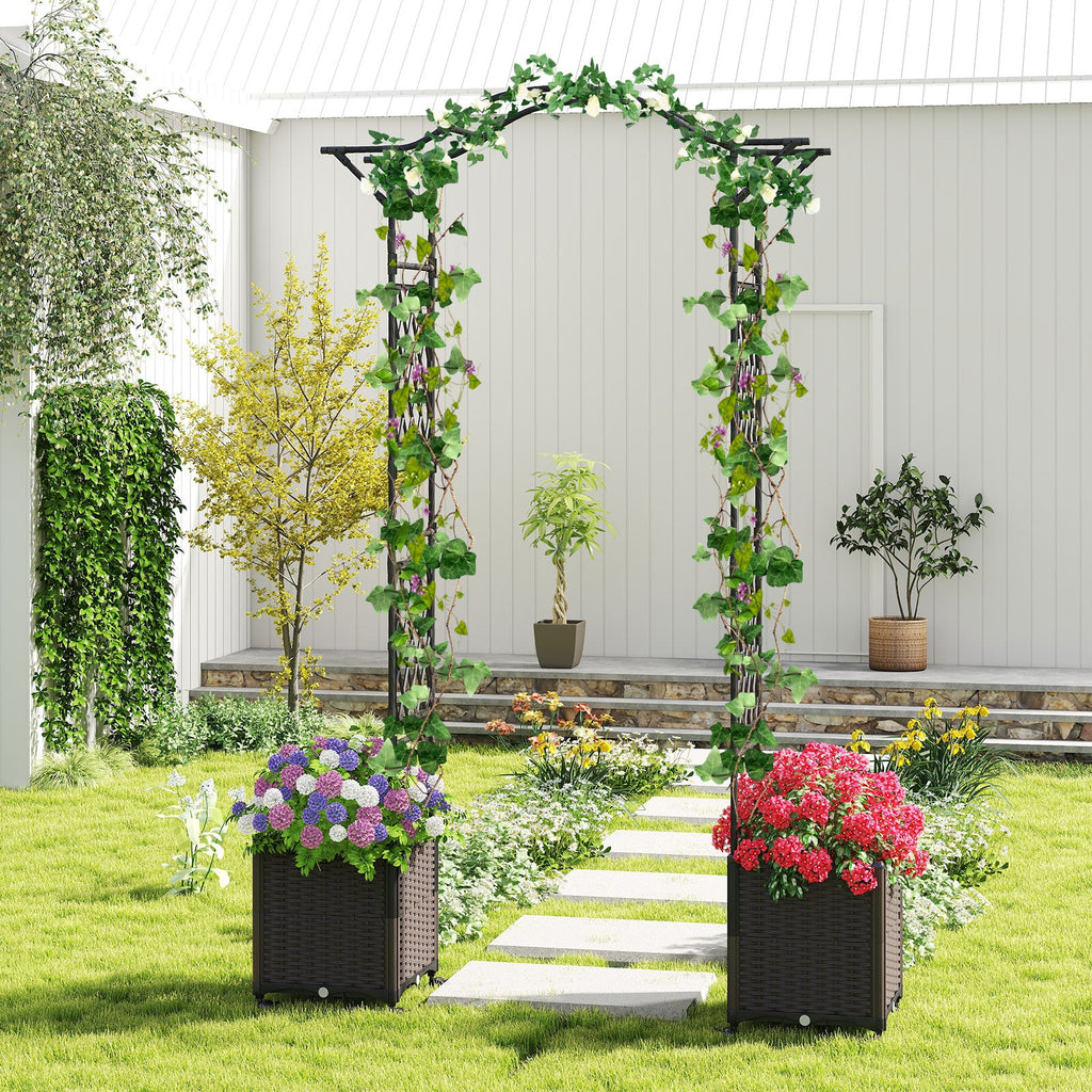 Black garden arch trellis with leafy vines and two wheeled planter boxes outdoors
