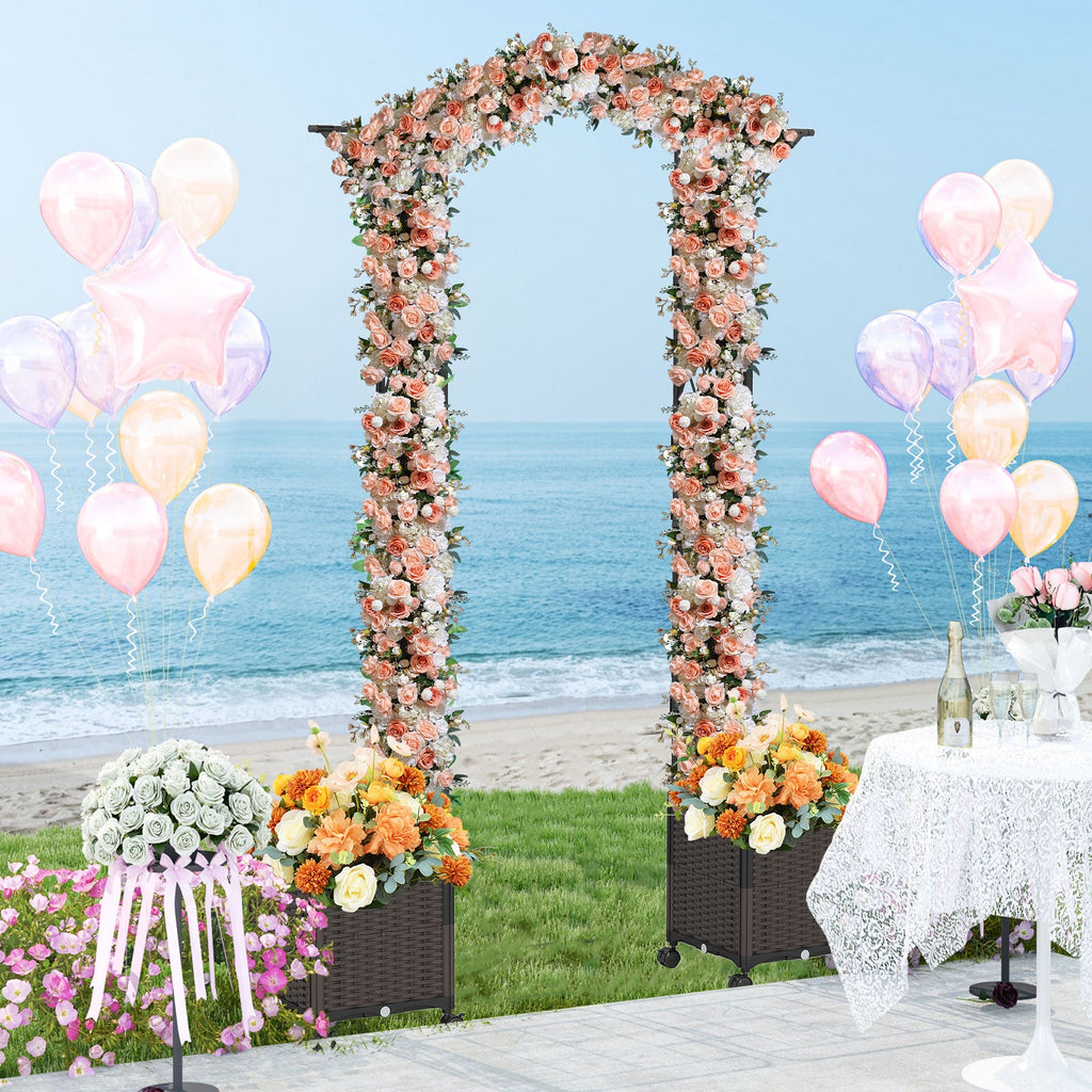 Floral garden arch trellis with two wheeled black planter boxes and blooming flowers