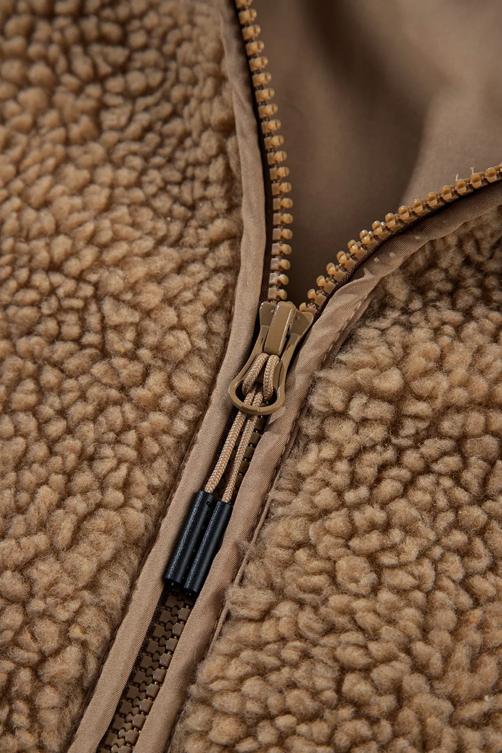Fleece zip-front detail with zipper pull and cord-tape trim