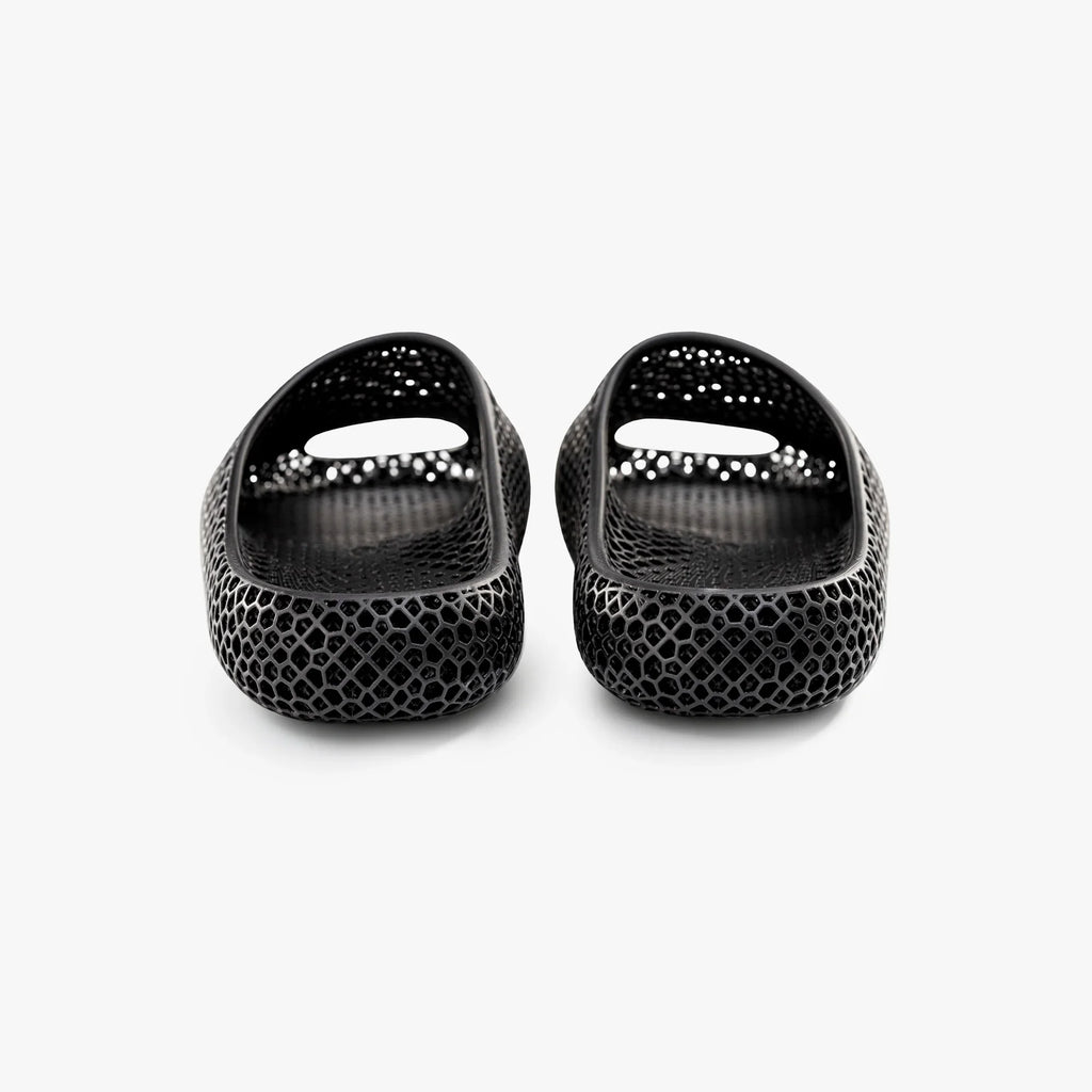 Black 3D-printed mesh slippers, front view with glossy toe openings.