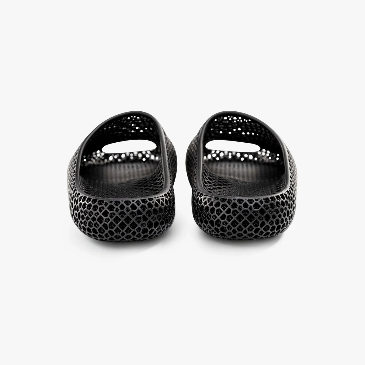 Black 3D-printed mesh slippers, front view with glossy toe openings.