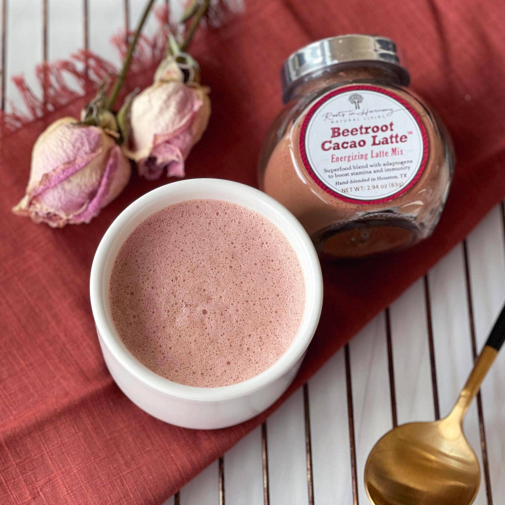 Beetroot cacao latte mix jar with label and a cup of frothy pink latte