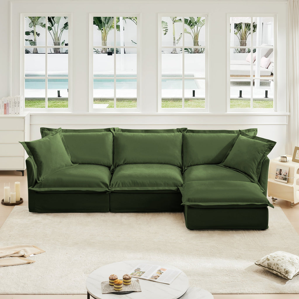 Green L-shaped slipcovered sectional sofa with three seat cushions and corner chaise