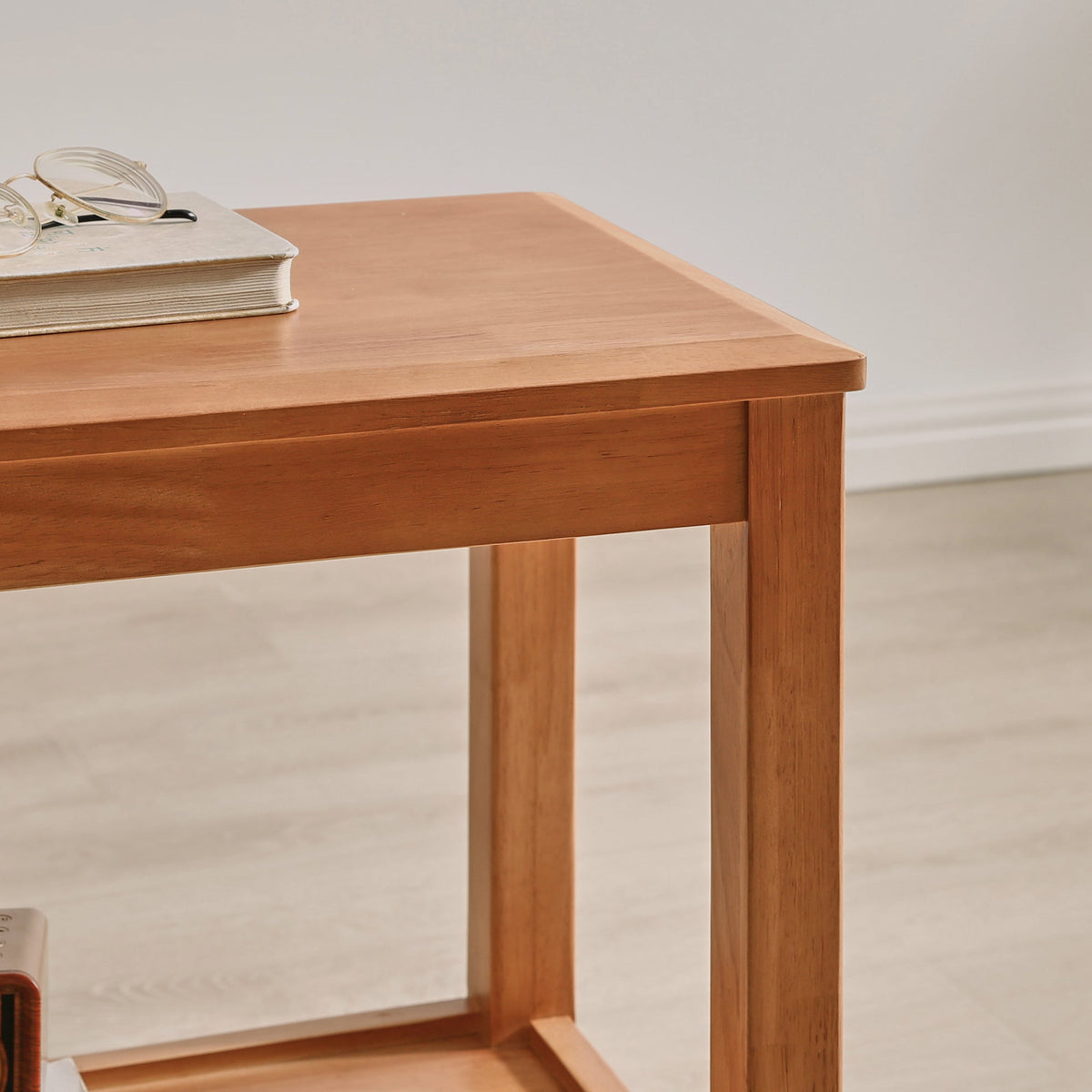 Wooden side table detail showing its smooth top and square legs