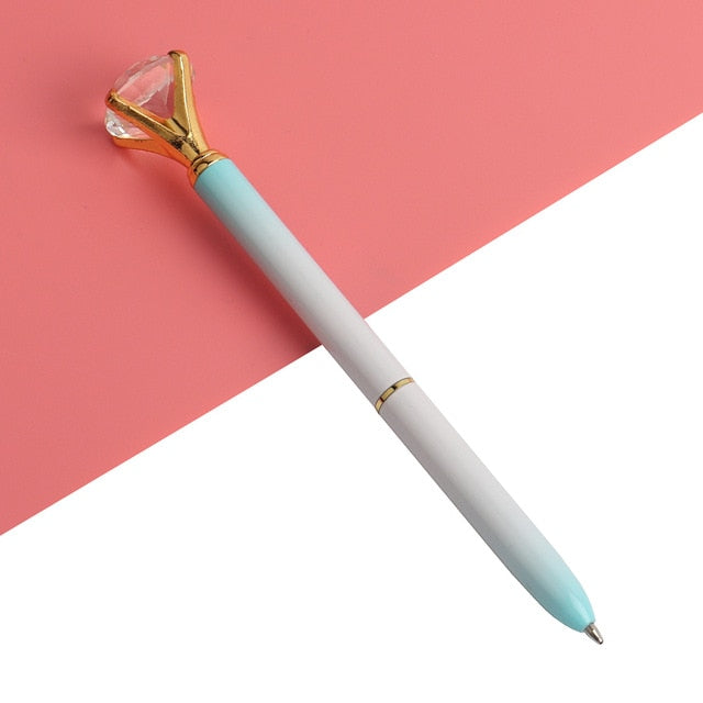 White-to-light-blue ballpoint pen with faceted gold gem top and metal tip