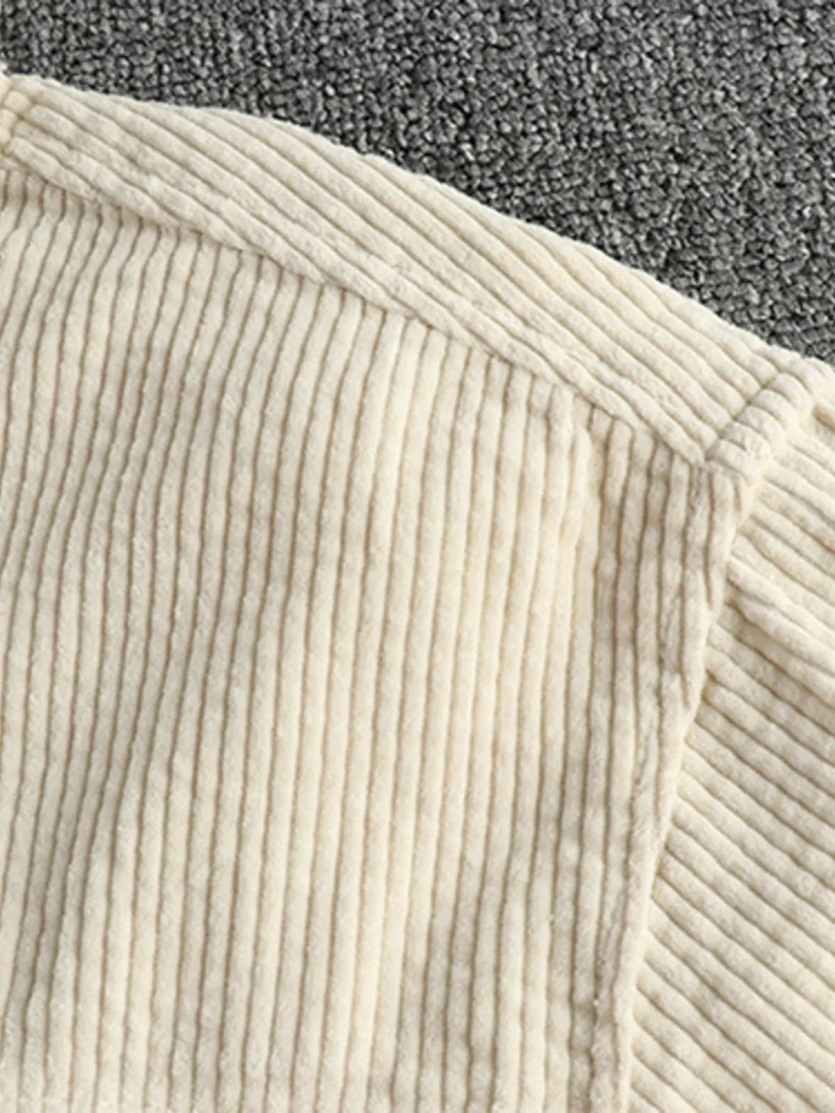 Light beige corduroy button-up shirt with vertical ribbed texture, partial collar