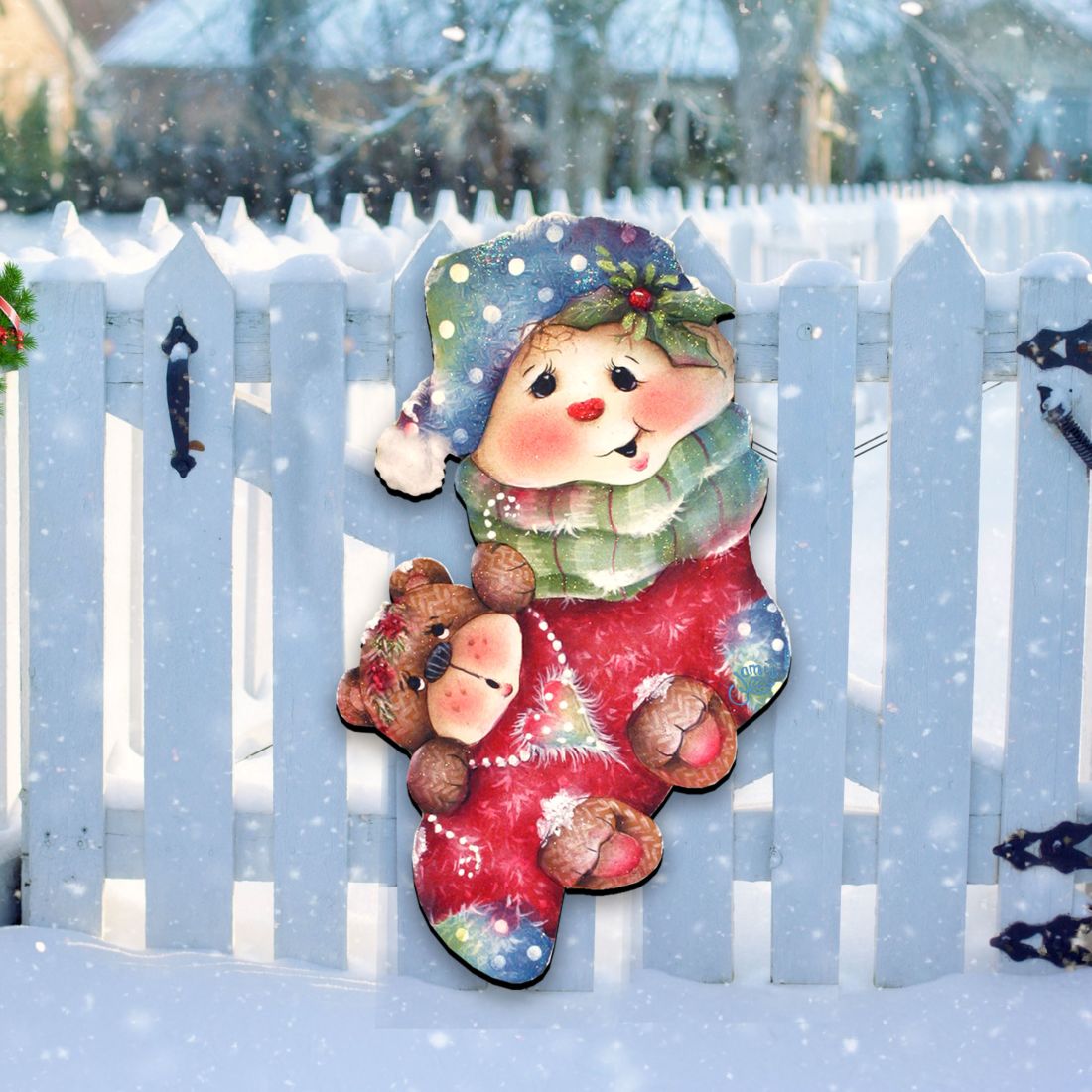 Close view of Christmas bear-themed door decor with red outfit and blue hat