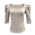 Cream long-sleeve medieval-style tunic top with scooped neckline and subtle vertical stripes