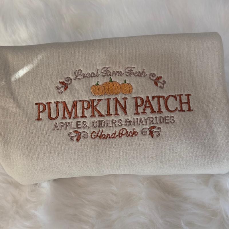Sand sweatshirt sleeve with embroidered “Pumpkin Patch” text