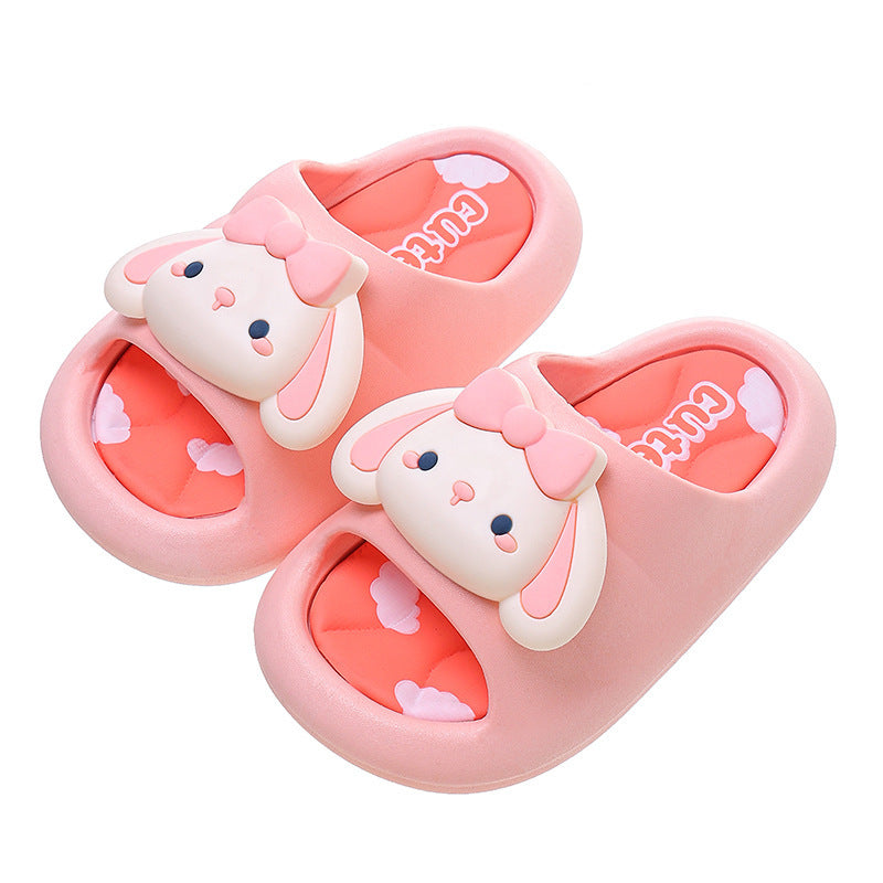 Kids bunny slide slippers in pink with bow, white ear face, and orange lining