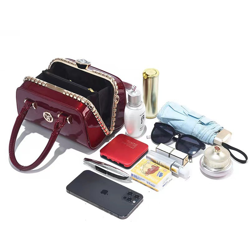 Wine red patent leather mini handbag with open top and gold-tone chain trim