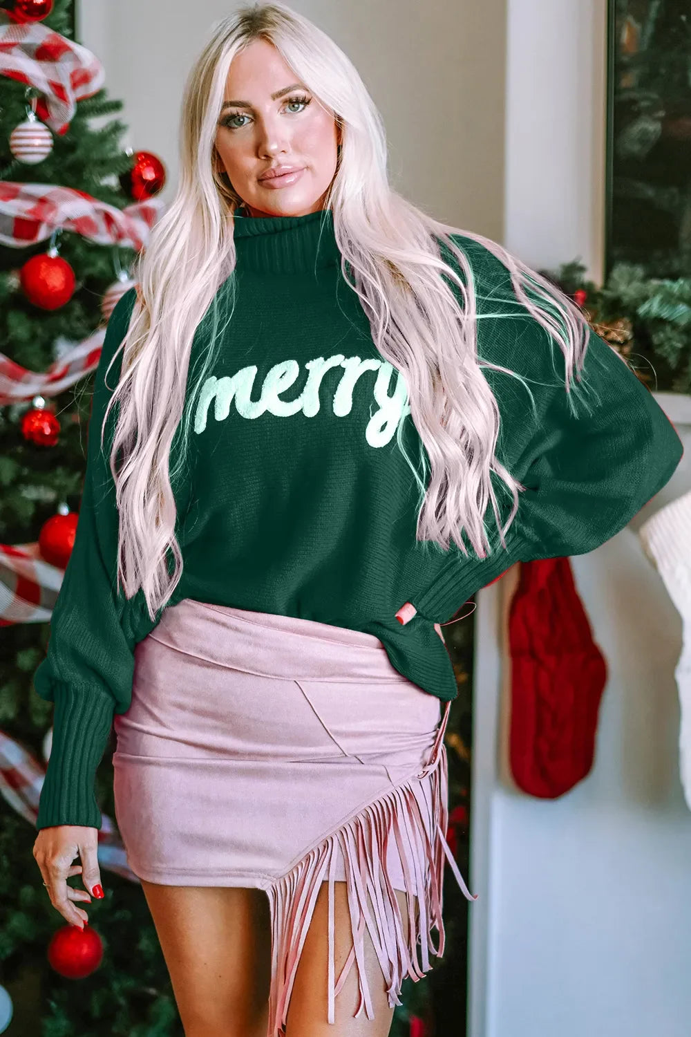 Dark green turtleneck sweater with long sleeves and 'merry' print