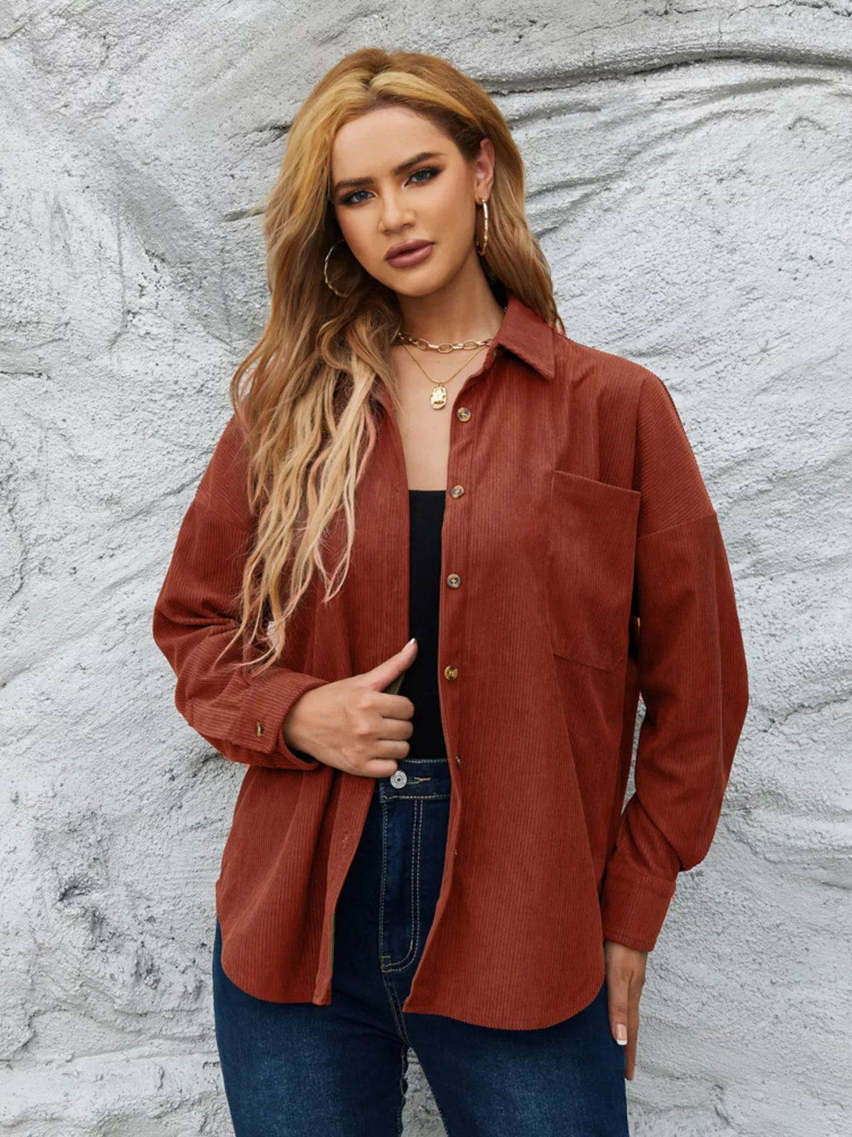 Rust corduroy button-up shirt with button front and a chest pocket