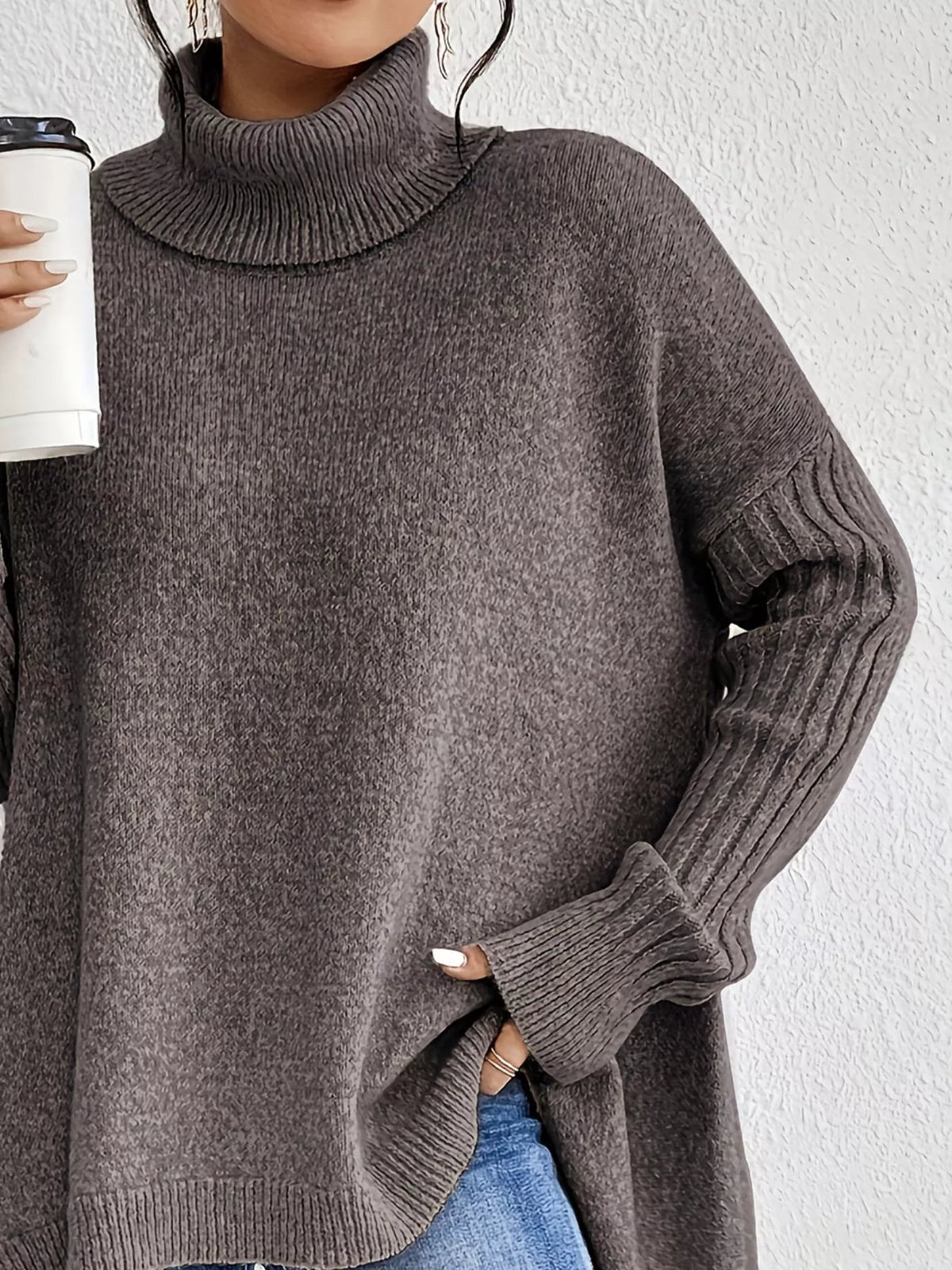 Grey turtleneck high-low hem sweater with long ribbed sleeves and knit cuffs