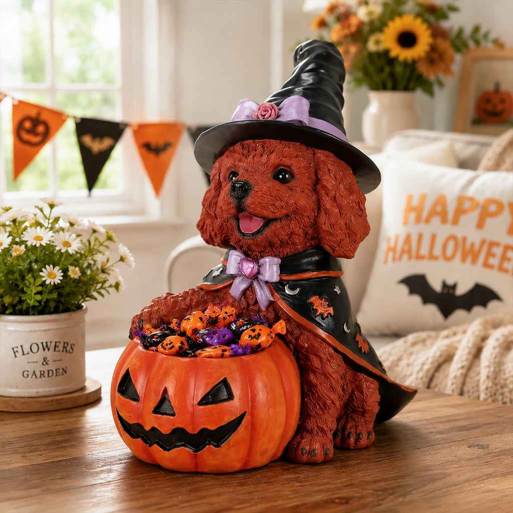Side view of a brown teddy dog figurine wearing a witch costume and holding a pumpkin bowl