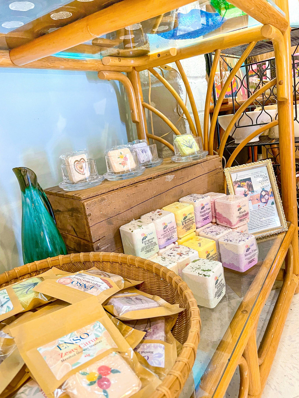 Bath bomb boxes on a wooden display shelf, stacked square cubes in bags