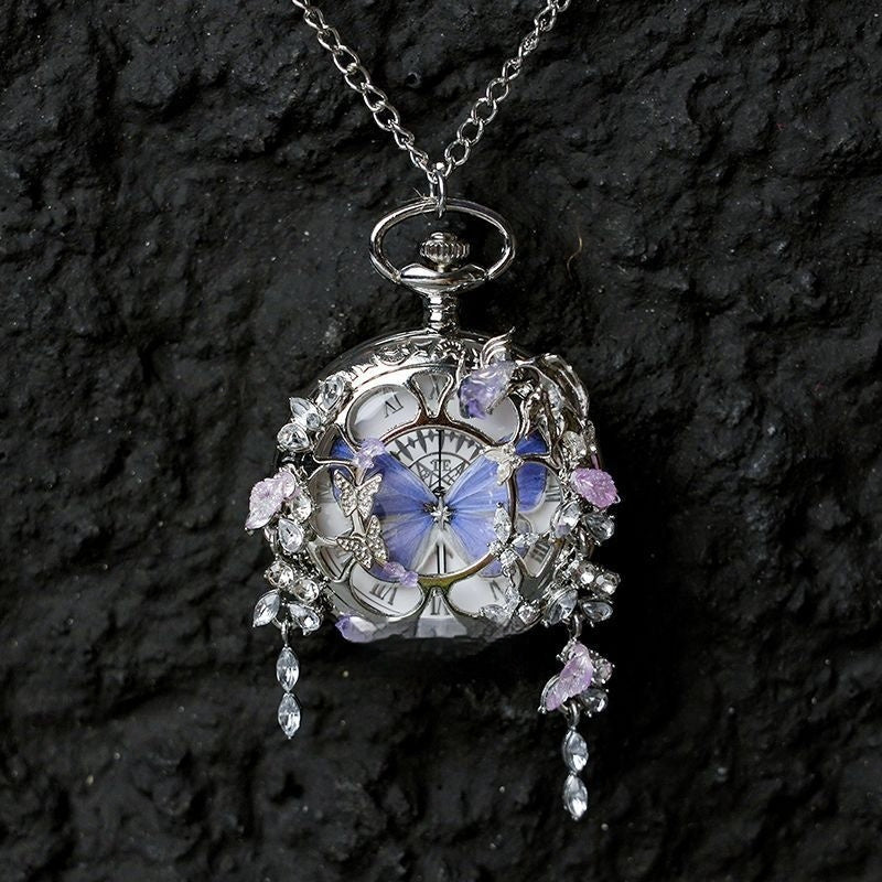 Butterfly pocket watch pendant necklace with blue butterfly accents and dangling crystal drops