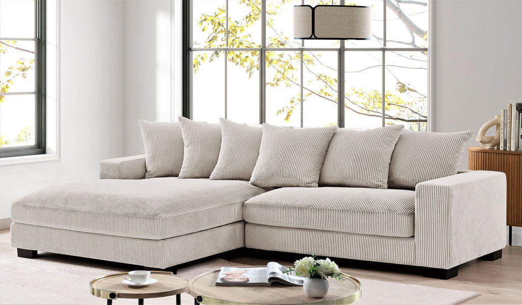L-shaped sectional sofa with chaise, beige textured upholstery and throw pillows