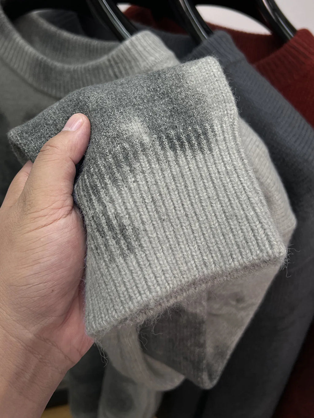 Gray ribbed hem sweater with mottled abstract print, folded sleeve cuff detail